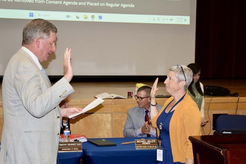 Board member being sworn in.