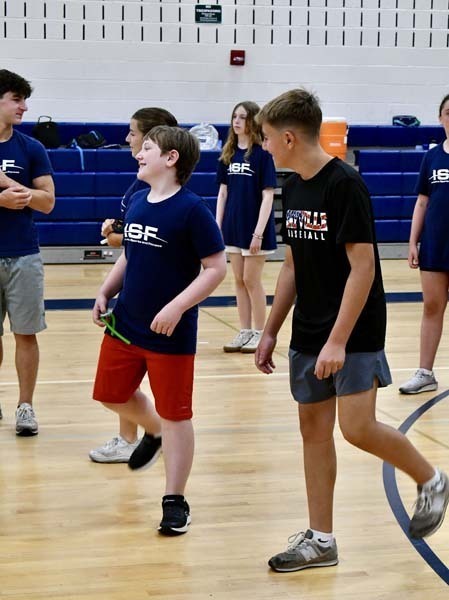 Students running indoors.