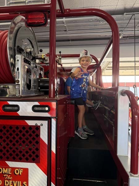 Student inside fire truck.