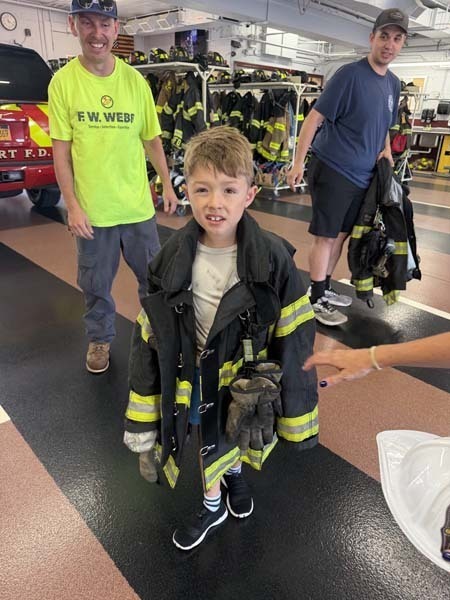 Student wearing firefighter uniform.