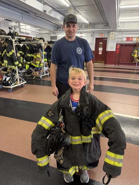 Student wearing firefighter uniform.
