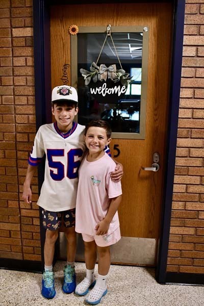 Students smiling in hallway.