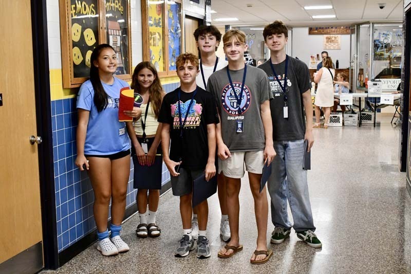 Students smiling in hallway.