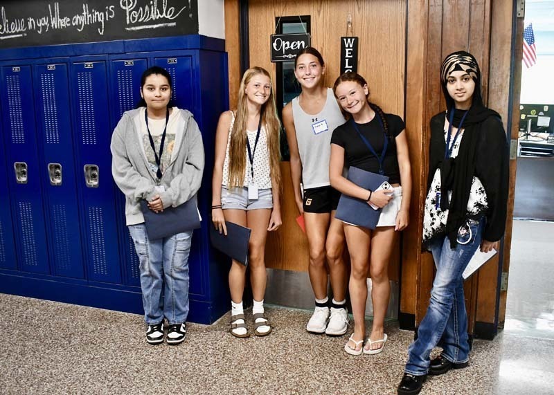 Students smiling in hallway.