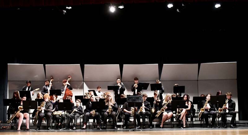 Student orchestra performing on stage.