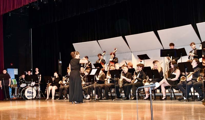 Student orchestra performing on stage.