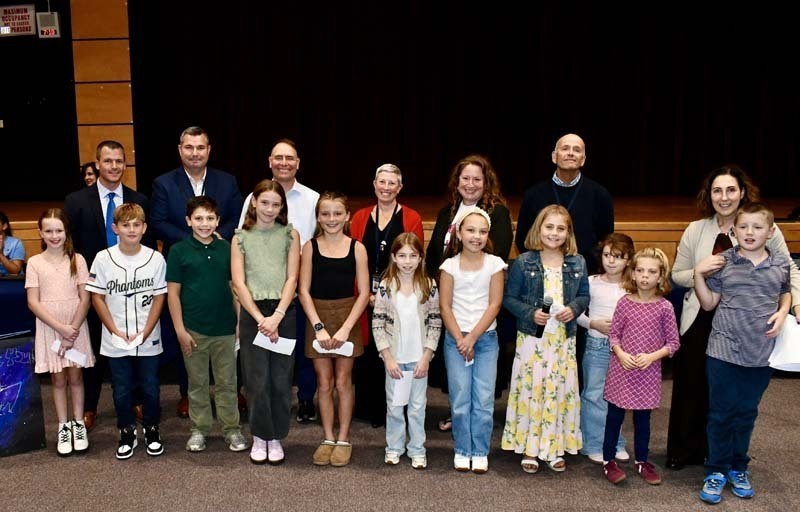 Students smiling with board members.