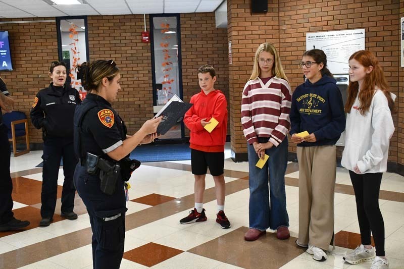 Students listening to Police and Fire Department representatives.