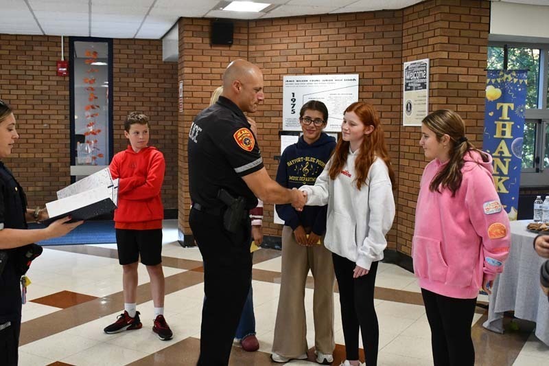 Students listening to Police and Fire Department representatives.