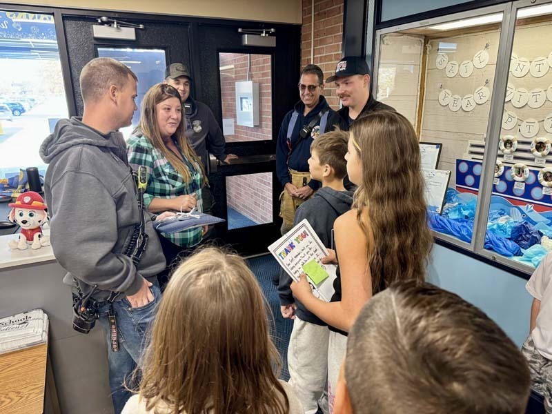 Students listening to Police and Fire Department representatives.