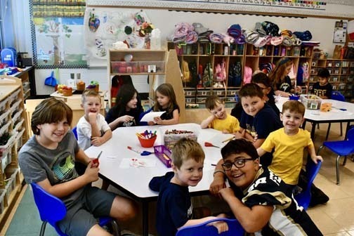 Students writing at table.