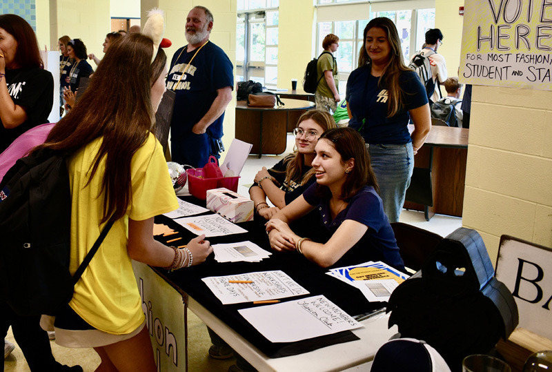 3 students at their booth