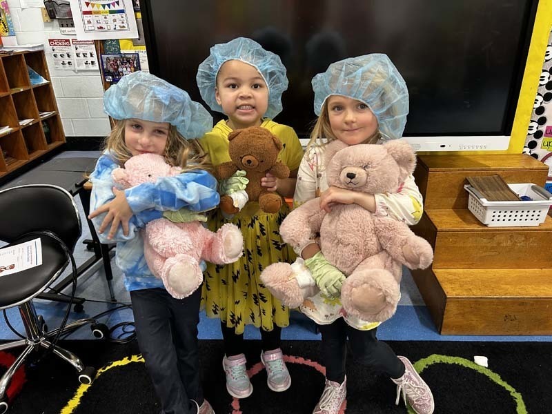 Students holding their Teddy Bears.