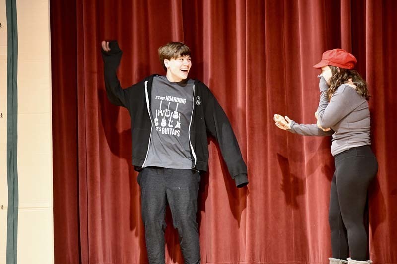 Students performing play on stage.