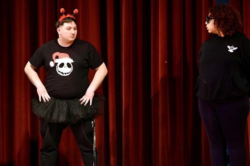 Students performing play on stage.