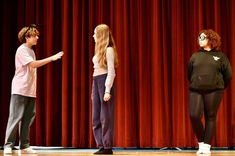 Students performing play on stage.