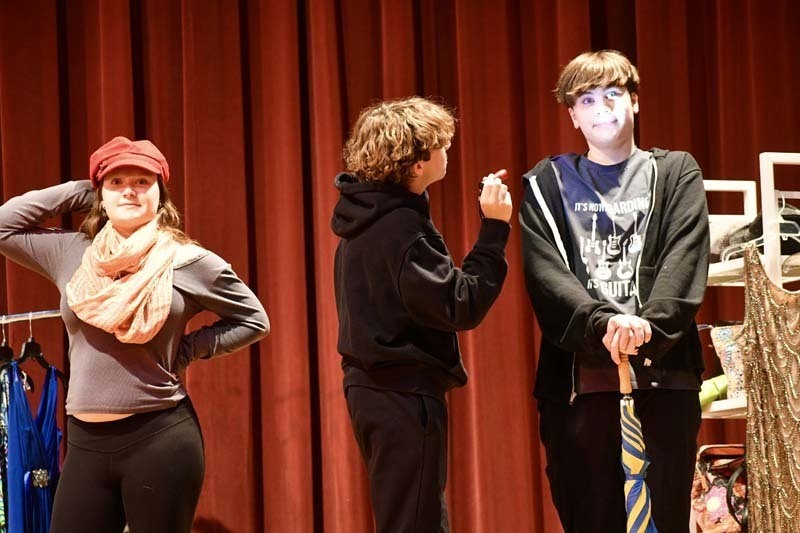 Students performing play on stage.