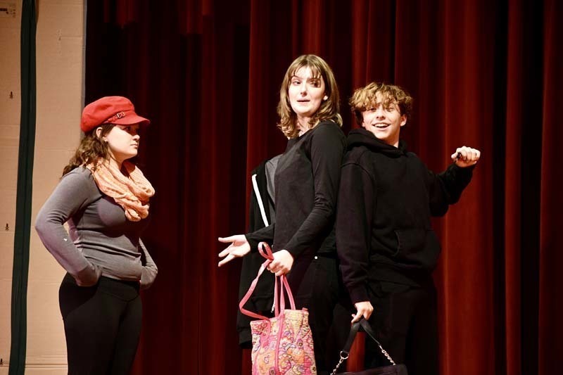 Students performing play on stage.
