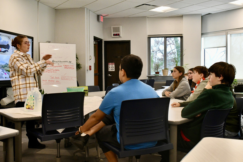 presenter speaking at front of class