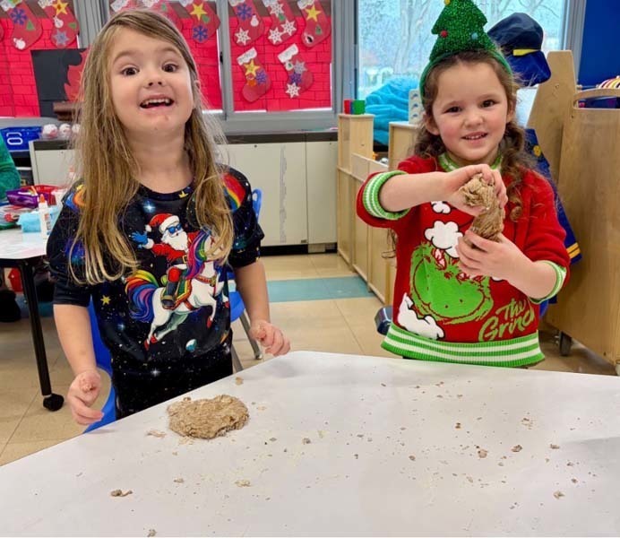 Student smiling while making art.