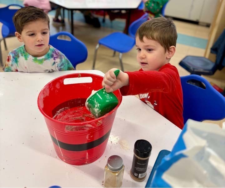 Student smiling while making art.