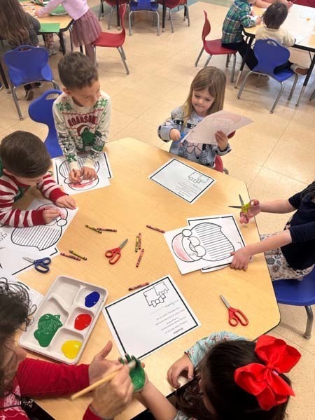 Student smiling while making art.