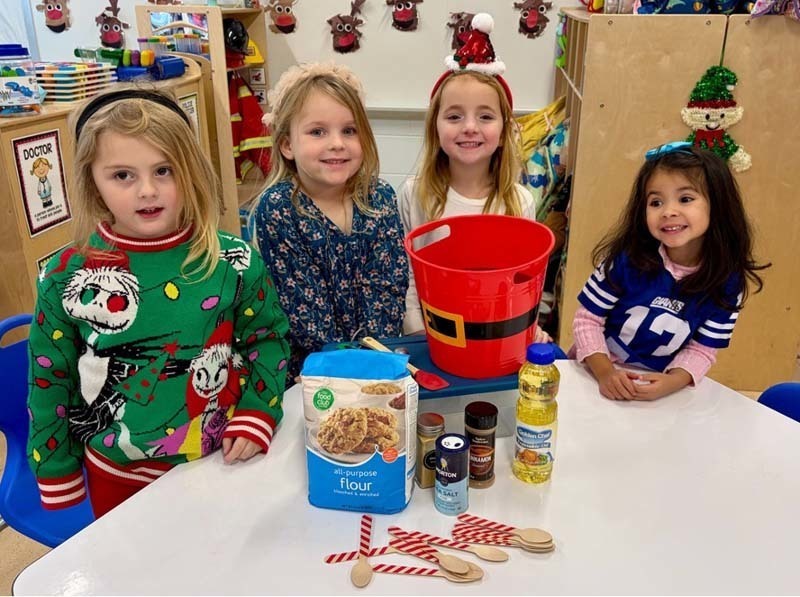 Student smiling while making art.