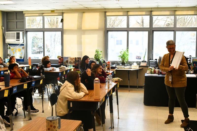 Students listening to older guest speak.