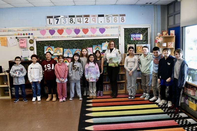 Students listening to older guest speak.