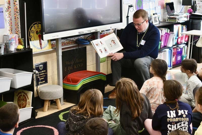 Students listening to older guest speak.
