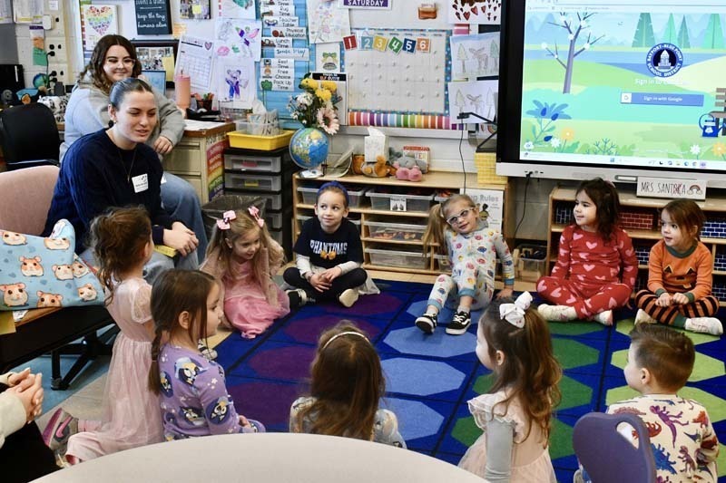 Students listening to older guest speak.