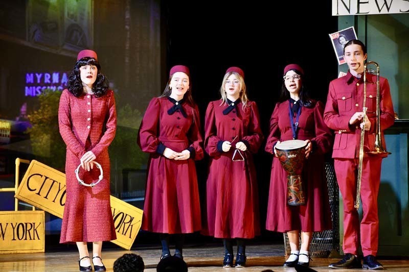 Students on stage in costume.