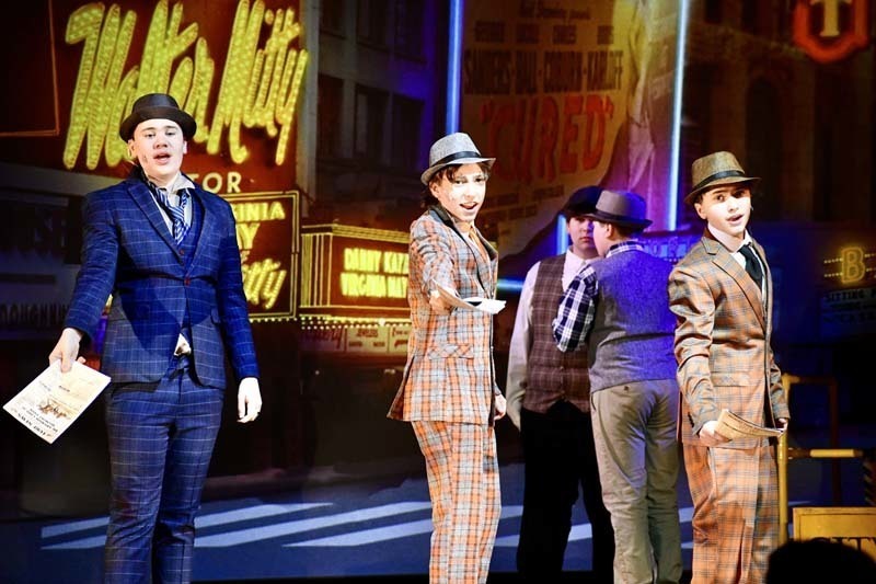 Students on stage in costume.