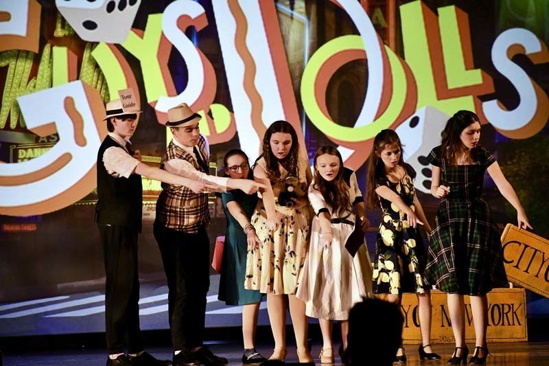 Students on stage in costume.