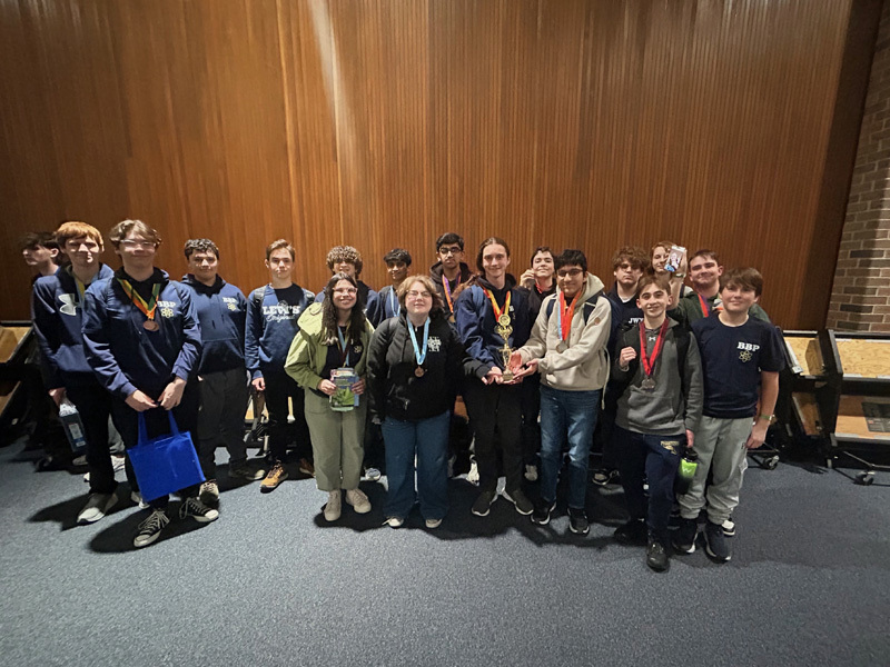 kids stand in a group photo on gray floor