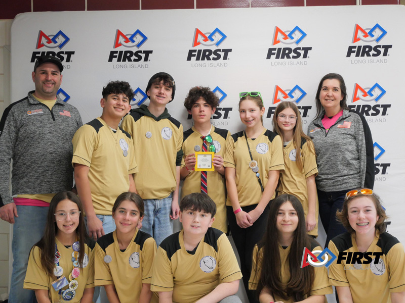 students in tan outfits stand in a row
