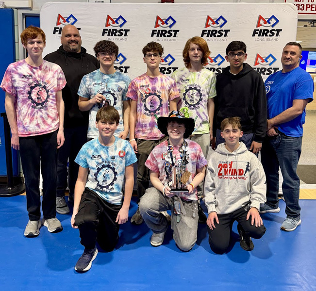 kids stand in a group photo on blue floor