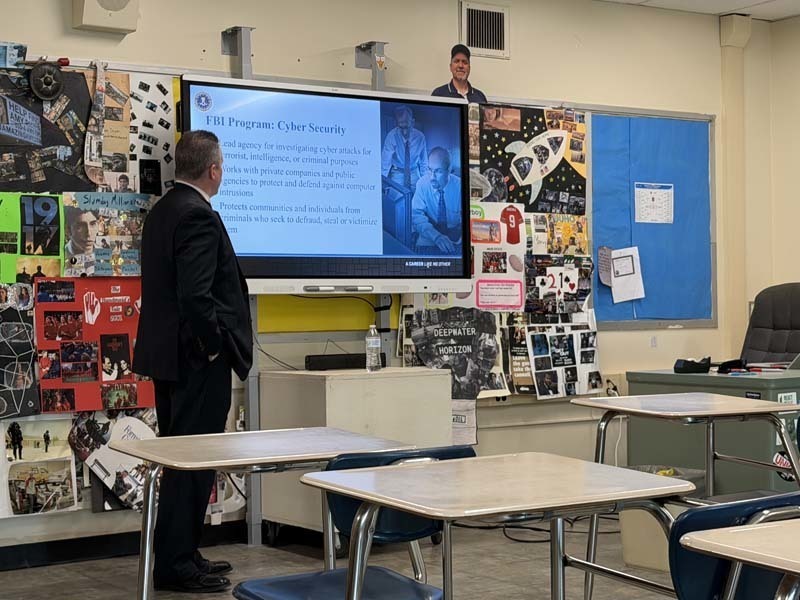 Man giving presentation to students.