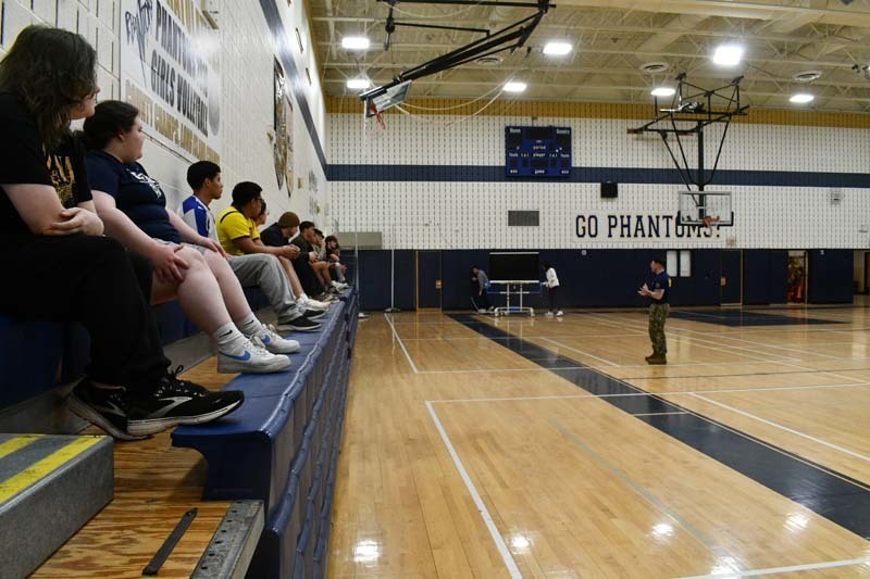 Students watching in bleachers.