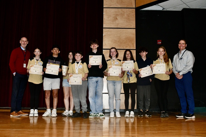 Students holding awards, with BOE members.