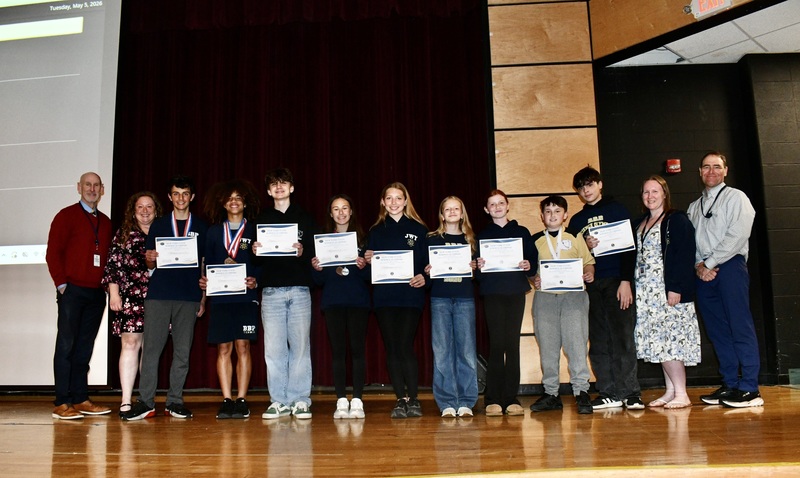 Students holding awards, with BOE members.