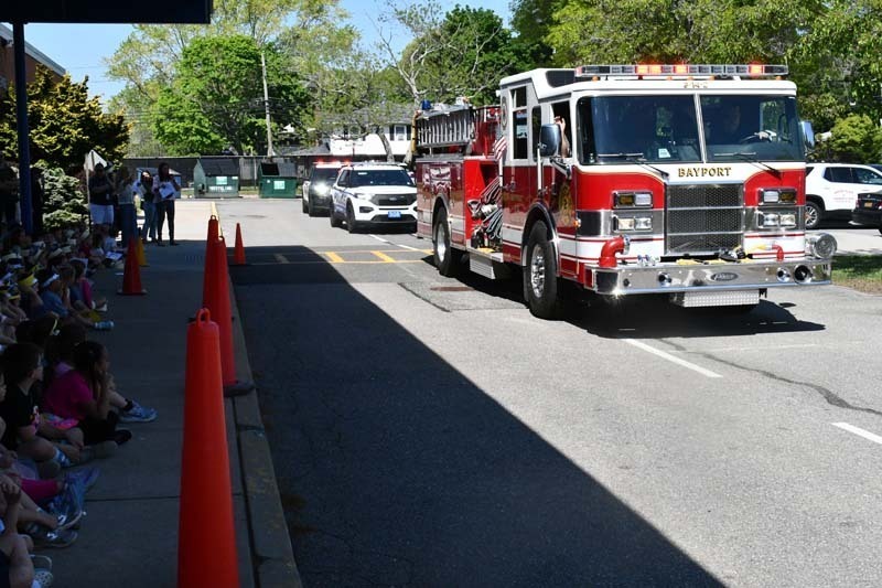 Fire truck passing by on the street.