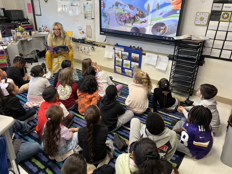 Ms. Young reading book to 3rd graders