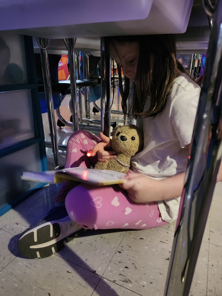 Student reading a book for flashlight Friday