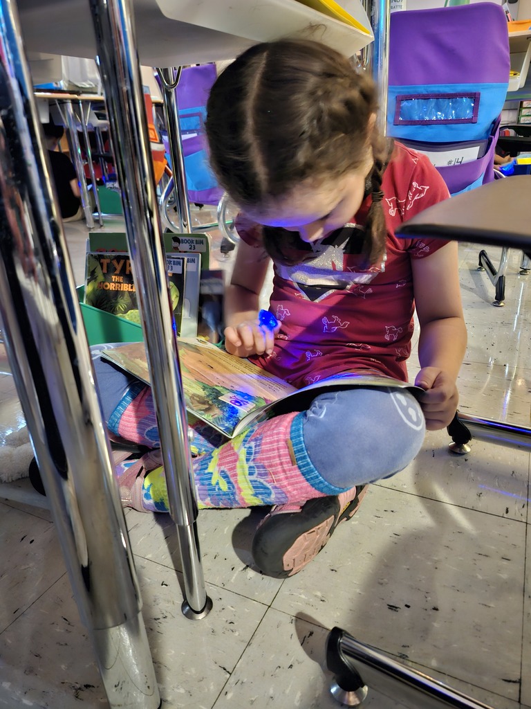 Student reading a book for flashlight Friday