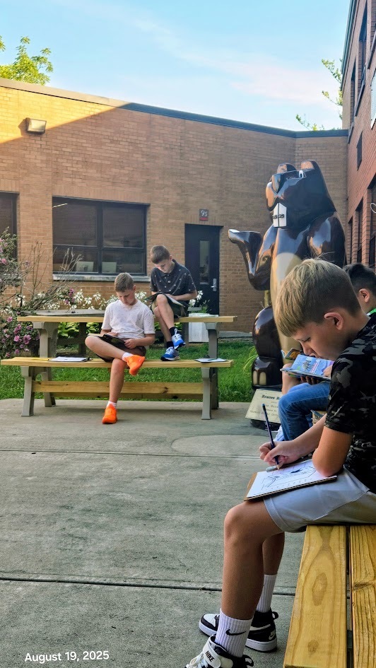 Students reading outside on a nice sunny day at Parkwood Elementary 