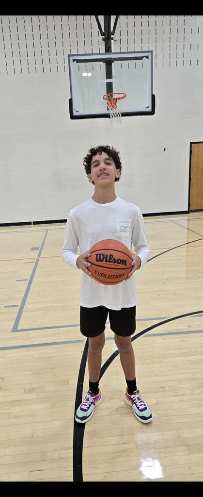 Intramural winner Juelz posing with a basketball 