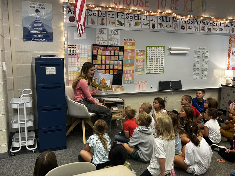 Lily Dague reading to students.