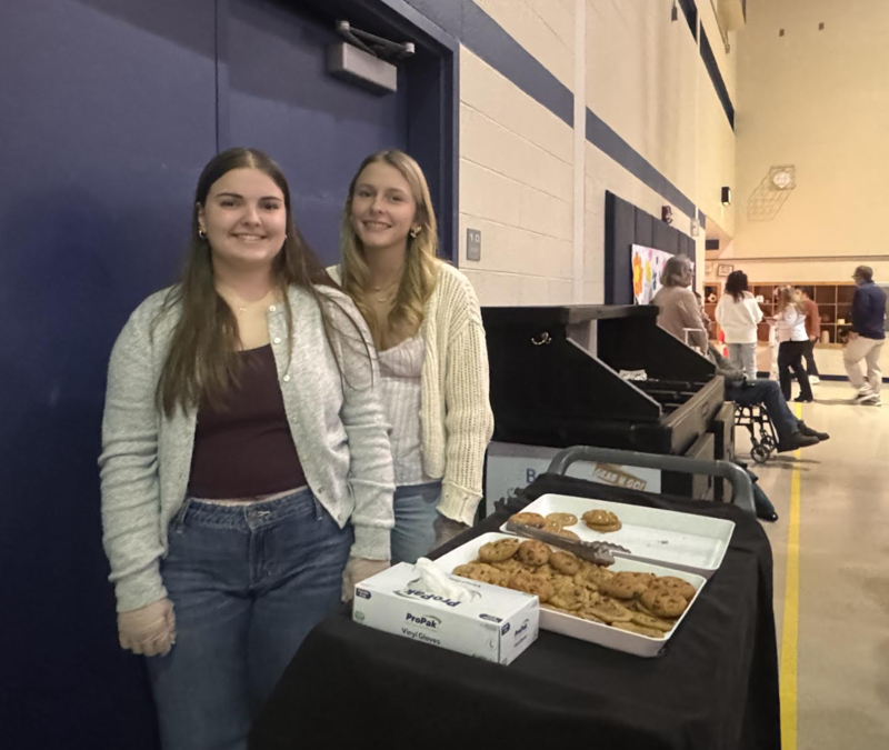 Rylee Lybarger and Chloe Pemberton serving cookies