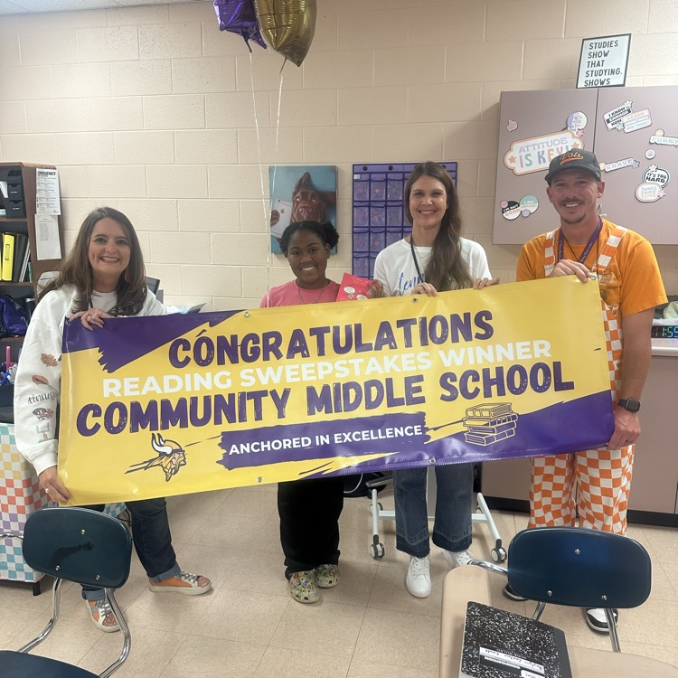 student and teachers with banner